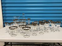 Full group of glasses, pitcher, and decanter on table