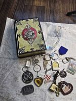 Lot overview showing decorative box, crystal, and assorted keychains