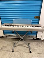 Full view of Yamaha P-60 on X-style stand with music rest