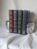 Four Reader's Digest Condensed Books standing between apple-shaped bookends