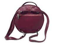 Rear view of burgundy round leather bag showing exterior zipper pocket, adjustable strap, hardware