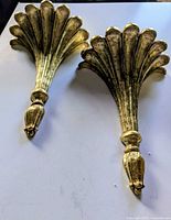 Front view of both gilded fan-shaped wall shelves