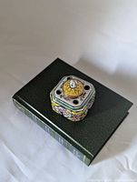 Top view showing floral panels and pen holes