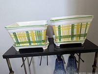 Front view of both rectangular planters on trays showing handpainted plaid design