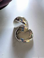 Both interlocking shakers nested together showing reflective silver finish