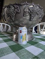 Front view showing grapevine relief and size reference with can