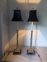 Full view of both buffet lamps standing side by side showing height, brass finish, shades and bases
