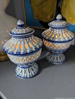 Both pierced blue and white urns lit from inside