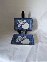 front view of both rectangular blue porcelain dishes on stand