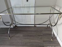 Full view of glass-top desk showing frame and feet