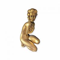 Front view of gold chalkware kneeling nude statue
