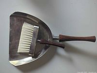 Brush nested inside pan showing overall design and materials