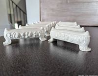 Group of Rosenthal Maria utensil rests showing relief design and feet