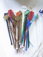 Cluster of casino-branded plastic swizzle sticks showing logos and varied colours