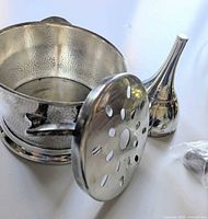 Wine bottle holder, funnel, and screen grouped together