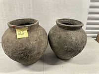 Front view of both concrete planters side by side