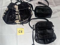 All three handbags displayed: snakeskin bucket, Guess crossbody, black crossbody