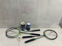 Four Black Knight Superlight racquets and two Yonex shuttlecock tubes with shuttlecocks