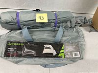 Complete packaged tent showing carry bag, handles, and label