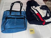Blue nylon tote and Tommy Hilfiger duffle displayed on table