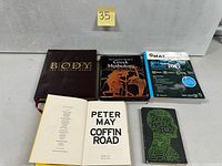 Six books arranged; titles and covers visible