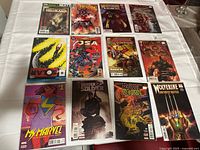 First set of 12 comics laid out on table