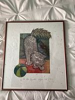 Full view of framed cat print under glass