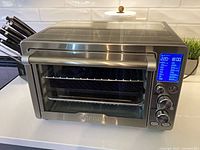 Front view of Gourmia stainless steel air fryer oven on countertop