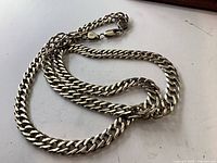 Full view of sterling curb chain laid out showing length and link style