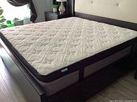 Mattress on bed frame showing top quilting and profile