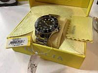 Watch in presentation box with tags visible