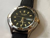 Front view of Elgin watch showing dial, bezel accents, and strap