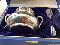 Sugar pot and scoop in fitted blue velvet box, lid removed
