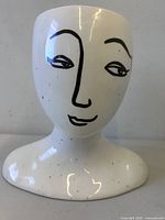 Front view of white ceramic bust planter with minimalist face design