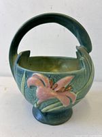 Front view showing lily motif, handle and form
