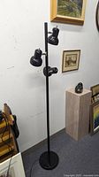 Full view of lamp showing three spotlights and base