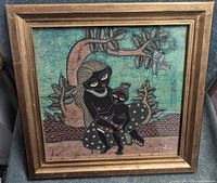 Front view of framed batik artwork showing full composition and gold frame