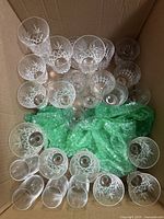 Top view of box showing multiple crystal stemware and tumblers