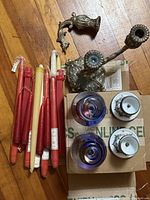Group shot showing all candles, enamel holders, glass votives, broken candelabra