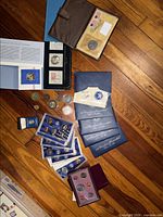 Overview of proof sets, folders, loose coins on floor