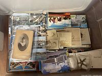 Top view of bin with stacks of postcards and portrait photos