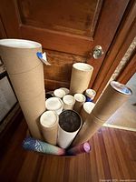 Group of assorted poster mailing tubes inside and around a box