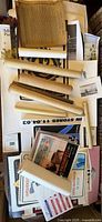 Top view of assorted rolled and flat posters in box