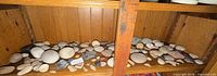 Wide shot of lower shelf showing majority of stones and fossils
