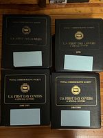 Front covers of the four binder albums showing titles and years