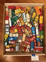 Top view of entire box of assorted die-cast vehicles