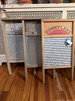 Three washboards side by side showing fronts and size comparison