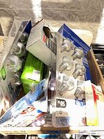 Box with multiple blister packs of GU10 halogen bulbs, LED bulb pack, loose bulbs