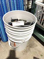 Bucket standing on floor, tools visible inside