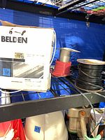 Belden box with cable spool, red and black wire spools on shelf